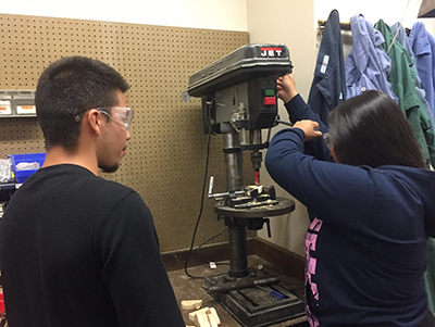 Students working a drill press