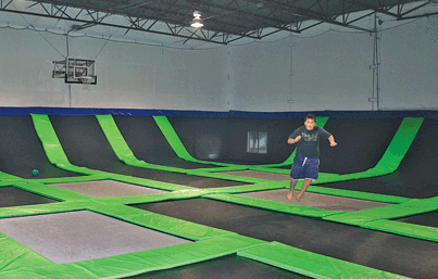 An employee jumps on a tampoline at G6 Airpark