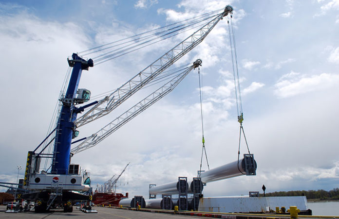 Crane lifting steel pipes