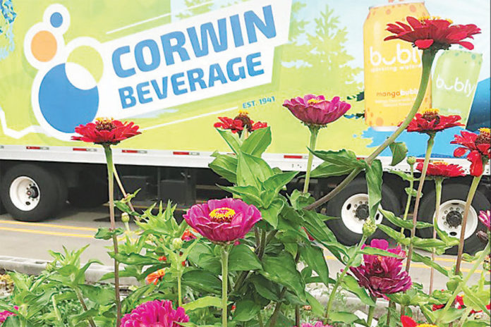 Corwin Beverage truck behind flowers