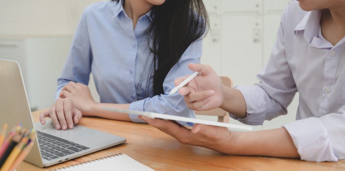 BusinessStrategy Two women at a table and laptop