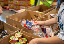 Clark County Food Bank Aims to Sustain Efforts Despite Funding Cuts Packing food
