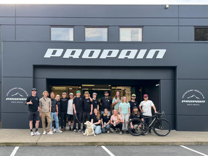 Propain Bicycles store front with staff